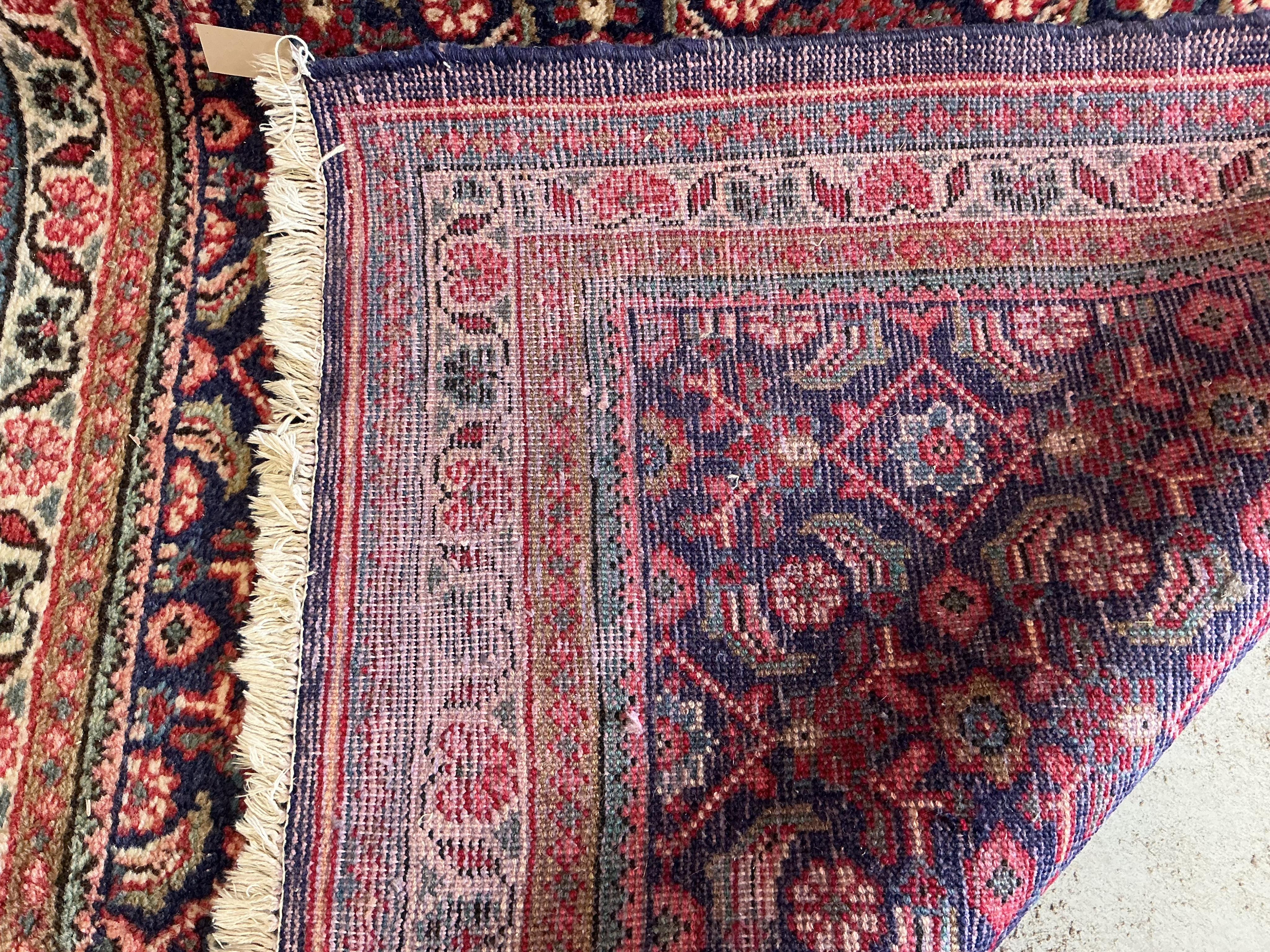 A Hamadan blue ground hall carpet, 322 x 122cm
